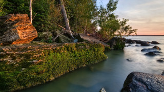 River rocks trees sunset boat - impressionist free wallpaper