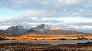 Mountain lake snow urban sunset - a lake in the foreground and a snow free wallpaper