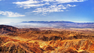 Mountain range clouds sunset fire - a view of a mountain range free wallpaper