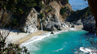 Waterfall cliff ocean beach nature - a sandy beach free wallpaper