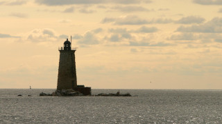 Lighthouse island ocean clouds sunset - a small island in the middle of the ocean free wallpaper