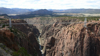Bridge canyon river mountains clouds - a river below free wallpaper