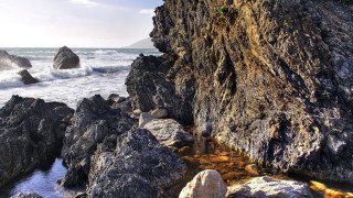 Rocky cliff water outcropping nature - a rocky cliff free wallpaper