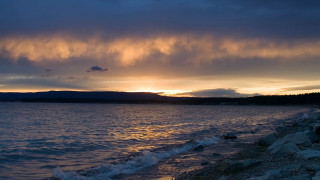 Sunset mountain water clouds city - a sunset over a body of water free wallpaper