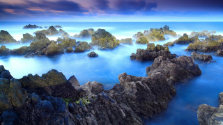 Lake rocks water plants mountains - a large body of water free wallpaper