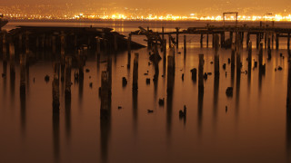 Water poles city sunset twilight - side and a city in the background free wallpaper