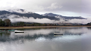 Lake mountains clouds boats reflection - low free wallpaper