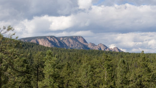 Mountain range trees clouds blue 2 - a mountain range free wallpaper