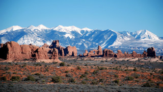 Mountain range snow capped landsacpe - a blue sky in the foreground free wallpaper