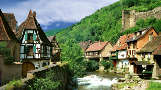 River village mountains trees clouds - a few building free wallpaper