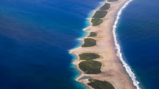 Aerial beach water plane island - a small island in the middle of the water free wallpaper