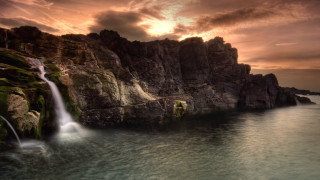 Waterfall over ocean sunset mountain - bascove free wallpaper for desktop