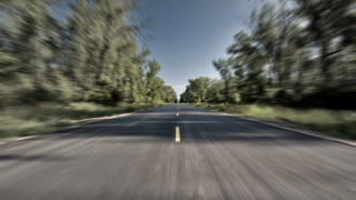 Blurry road trees blue sky - both side of it free wallpaper