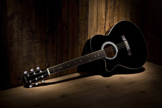 Guitar wooden table dark room - a guitar free wallpaper