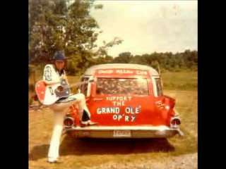 Man sitting red car guitar 2 - his hand and a sign free wallpaper