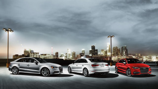Three colored cars parking lot 2 - a city skyline in the background free wallpaper