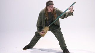 Man green outfit holding pole - a green outfit holding free wallpaper