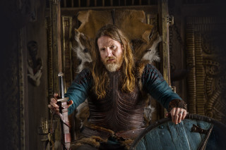 Man long hair beard sitting 2 - a chair holding free wallpaper