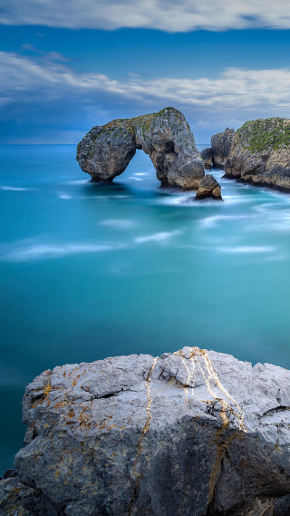 Rock formation ocean bridge blue - free nature wallpaper