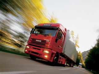 Red truck driving street forest - a red truck free wallpaper