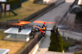 Orange black drone flying city - product photo free wallpaper