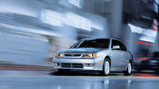 Silver car driving street tall 4 - a tall building free wallpaper