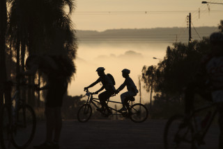 Biking group forest fog sunset - a group of people riding free wallpaper