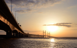 Sunset bridge water boat city - a boat in the foreground free wallpaper