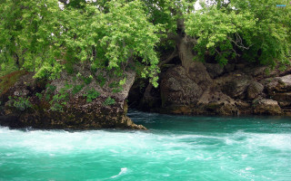 River rocks trees blue water - impressionist free wallpaper