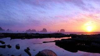 Sunset rocky beach water stacks - a sunset over a rocky beach free wallpaper