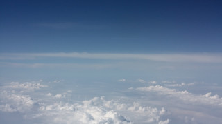 Sky clouds plane mountains ocean - cloud below free wallpaper