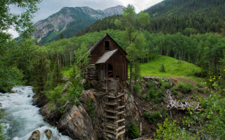 Cliffside wooden house river mountains - a wooden building free wallpaper