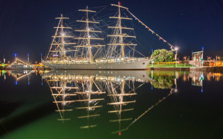 Large boat docked night sails - reflection free wallpaper