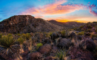 Sunset mountain range bushes rocks - a sunset over a mountain range free wallpaper