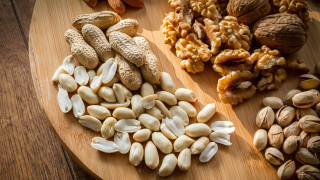 Nuts peanuts wooden plate food - a table top free wallpaper