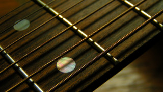 Guitar neck closeup blurry frets - a close up of a guitar neck free wallpaper