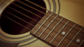 Guitar frets closeup black background - shallow free wallpaper for desktop