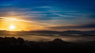 Sunset mountain range clouds trees 2 - a sunset over a mountain range free wallpaper