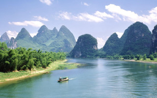 River mountains boat sky clouds - a few person free wallpaper