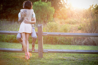 Couple standing fence grass field - a couple of people free wallpaper for desktop