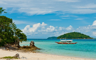 Beach boat island clouds saturated - a small island in the background free wallpaper