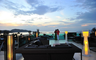 Balcony couple ocean sunset city - a couple standing free wallpaper