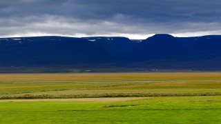 Horse grazing mountains water sunset - the background in the distance free wallpaper