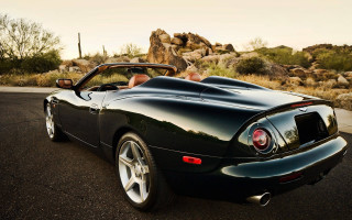 Black sports car cactus rocks - the side of the road in front free wallpaper