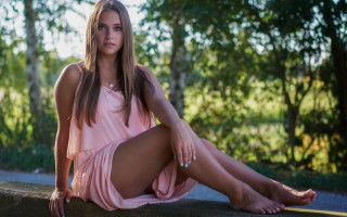 Woman pink dress sitting woods - a rock free wallpaper