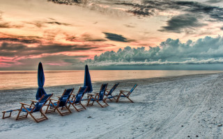 Beach chairs sand cloudy sky - a sandy beach under a cloudy sky free wallpaper