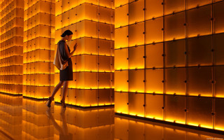 Woman orange lights cellphone backpack - ambient lighting free wallpaper