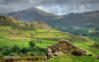 Stone building green valley mountains - free landscape wallpaper for desktop