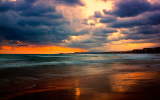 Sunset ocean clouds beach building - a sunset over the ocean free wallpaper