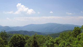 Mountain range forest lake sky 7 - a view of a mountain range free wallpaper